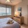 bedroom with large window and ceiling fan