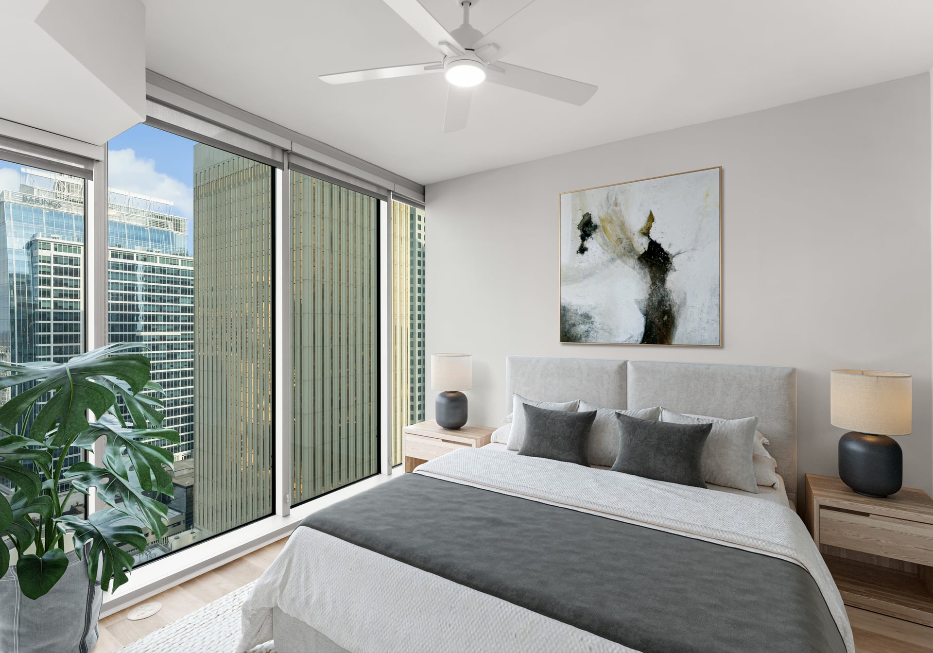 Modern bedroom with large windows, city views, a bed, bedside tables, lamps, a plant, and abstract art.